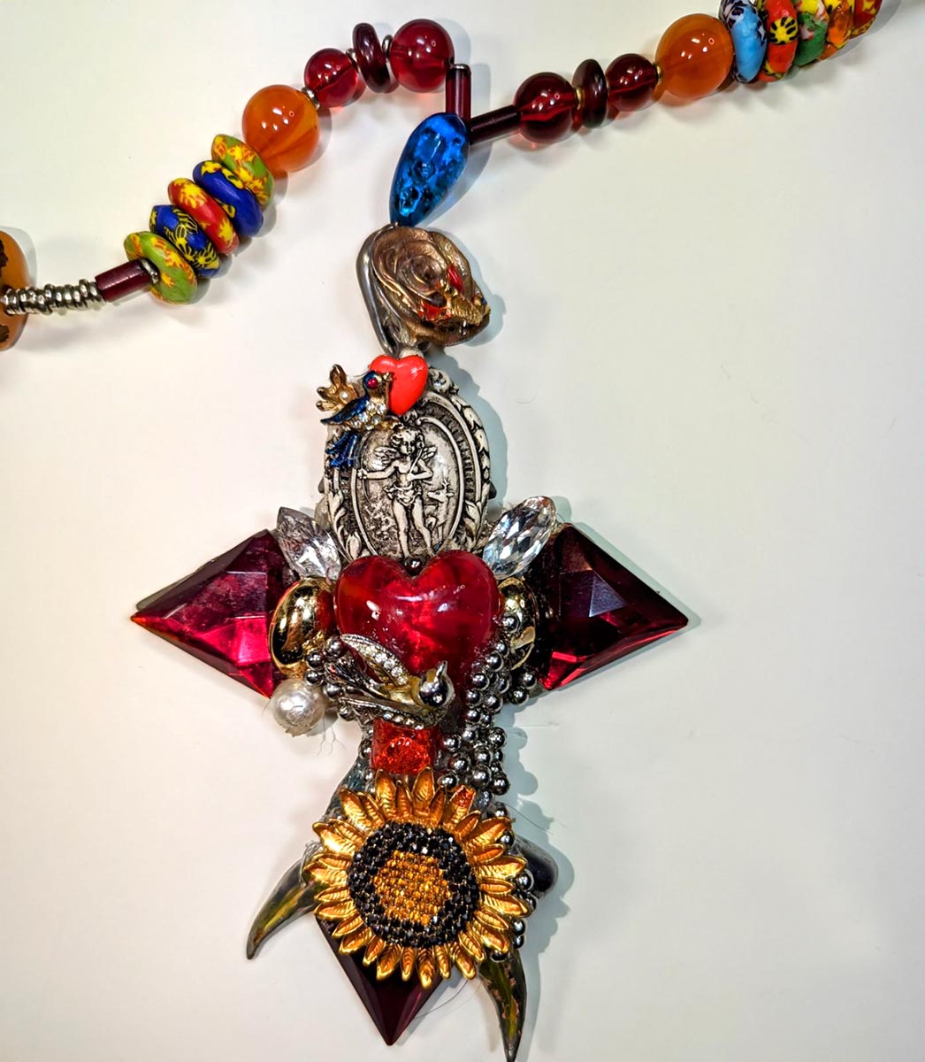 Beaded Necklace with Cross and Sunflower - pendant detail. Necklace by Wendy Gell, 2024